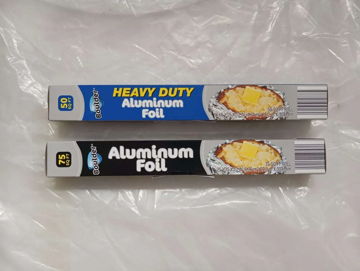 Branded aluminum foil rolls stacked in retail-ready cartons